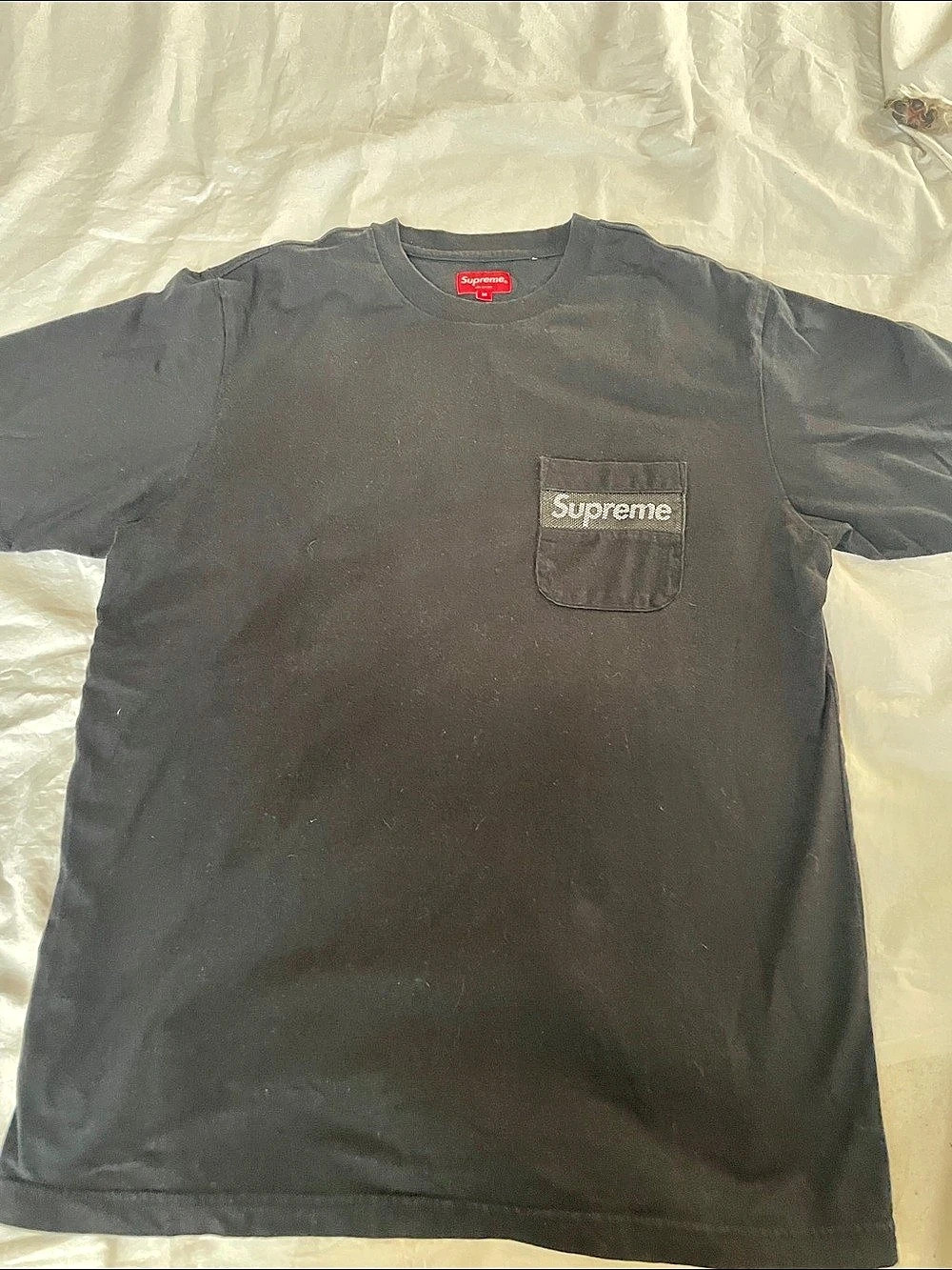 This shirt is the Supreme Mesh Stripe Pocket Tee in Black (released in 2019)